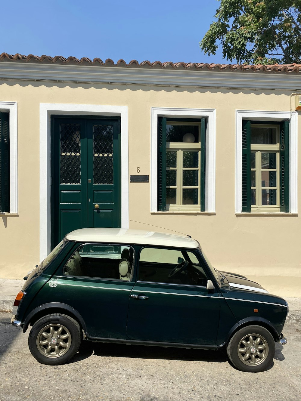 a small car parked in front of a house