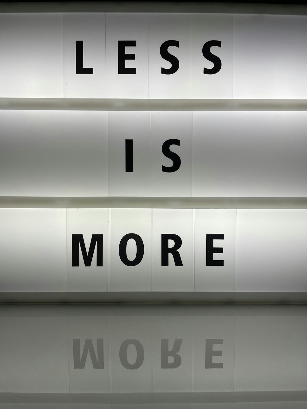 a sign that says less is more on it