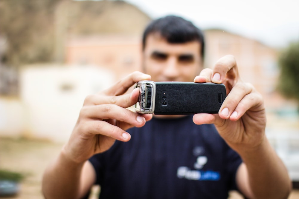 a man taking a picture with his cell phone