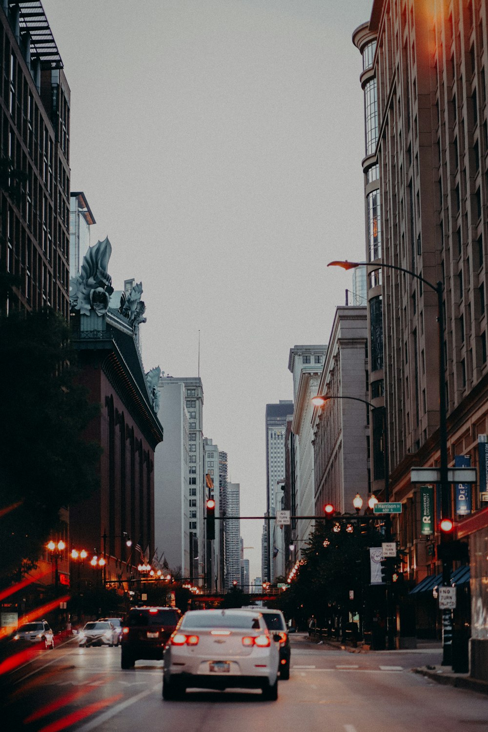 a car driving down a street next to tall buildings