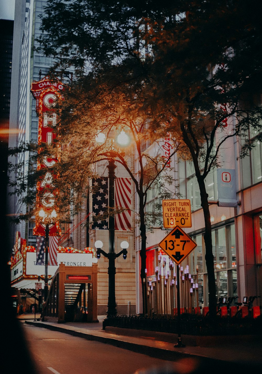 a city street at night with lights and signs