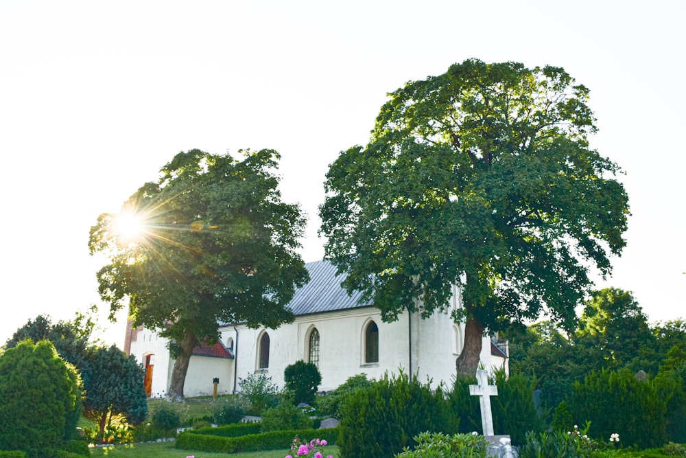 a white church with a cross in front of it