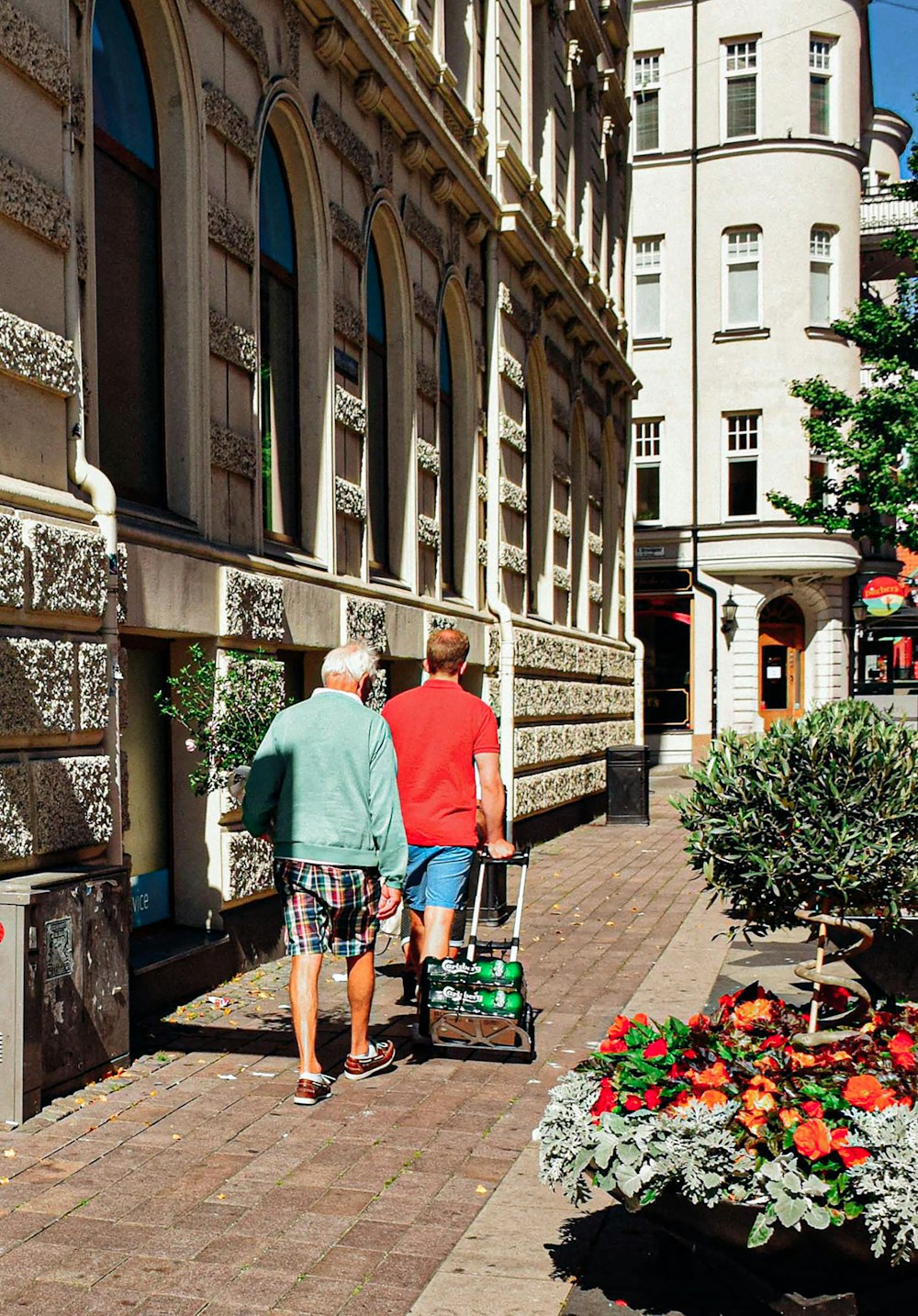 a couple of people walking down a street