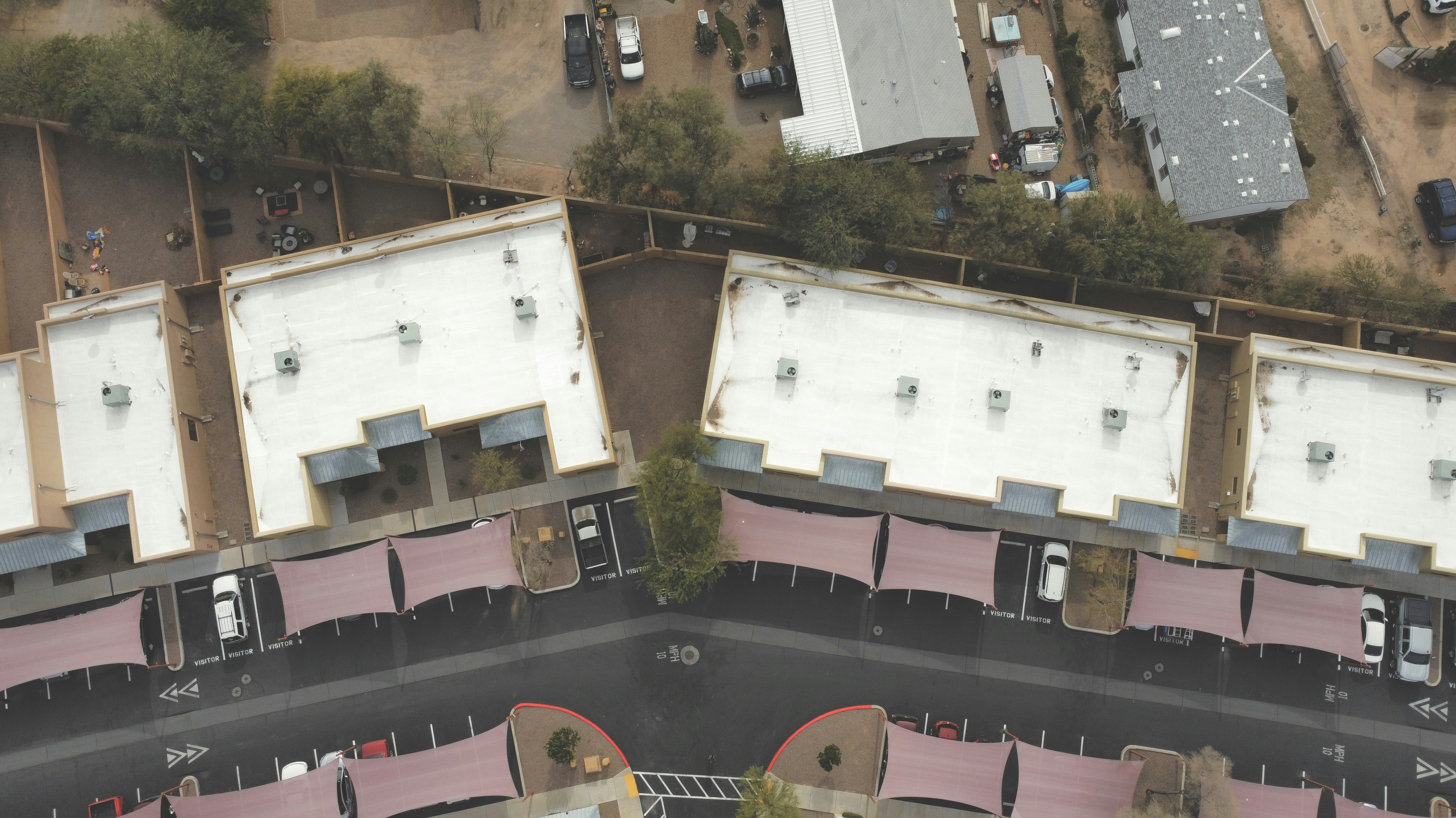 an aerial view of a parking lot and a building
