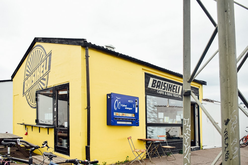 a yellow building with a bike parked in front of it