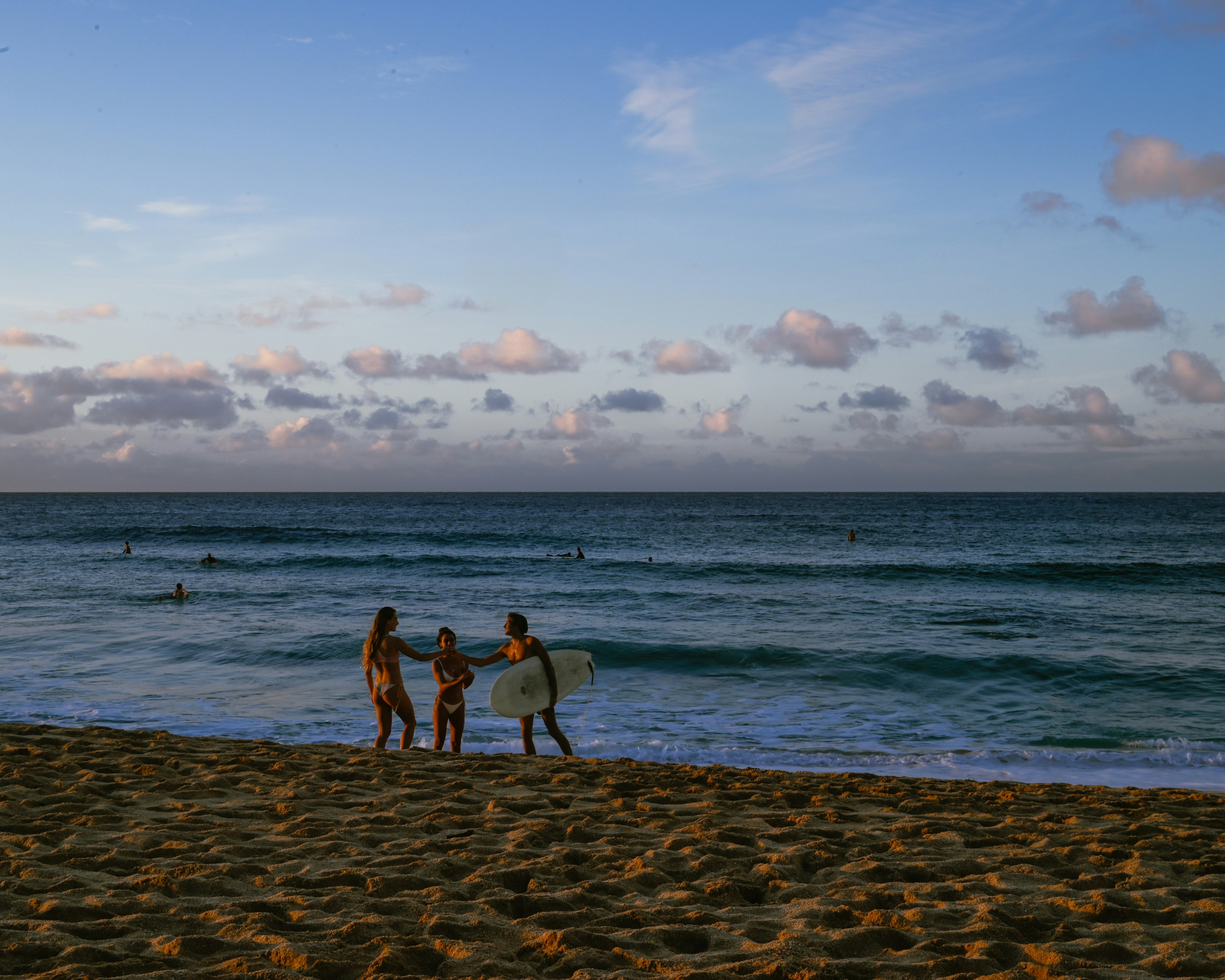 Family learning to surf on a Maui beach