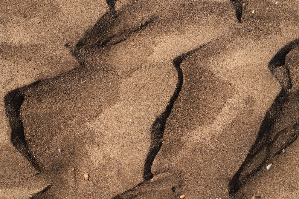 a close up of sand and water on a beach