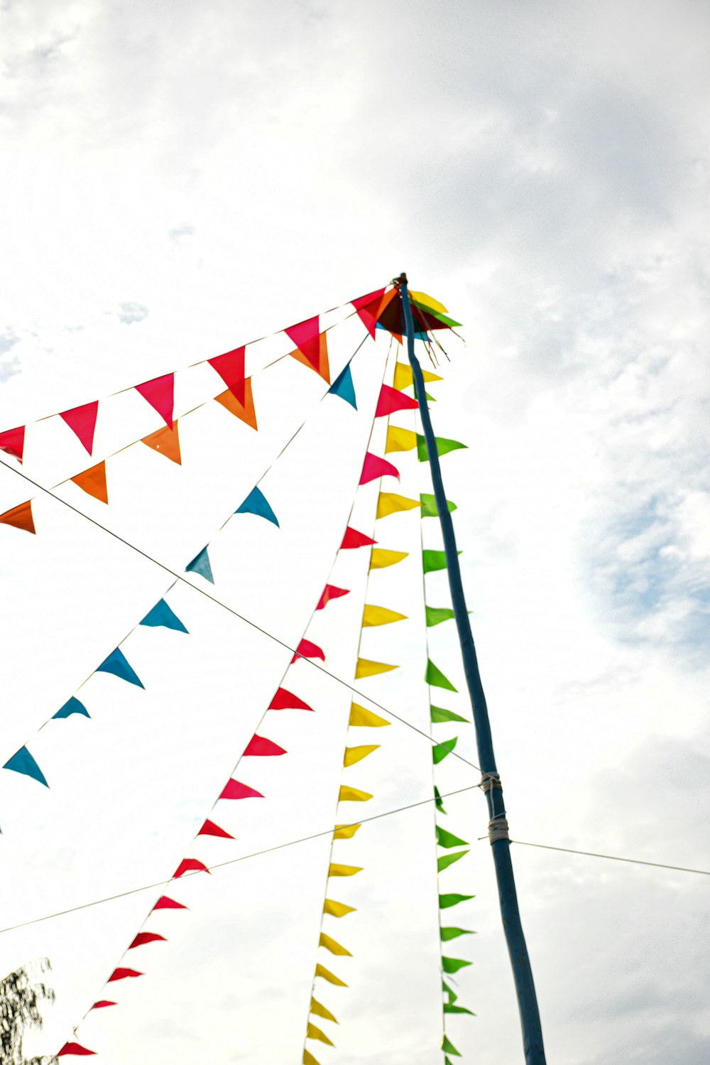 a pole with a bunch of colorful flags hanging from it