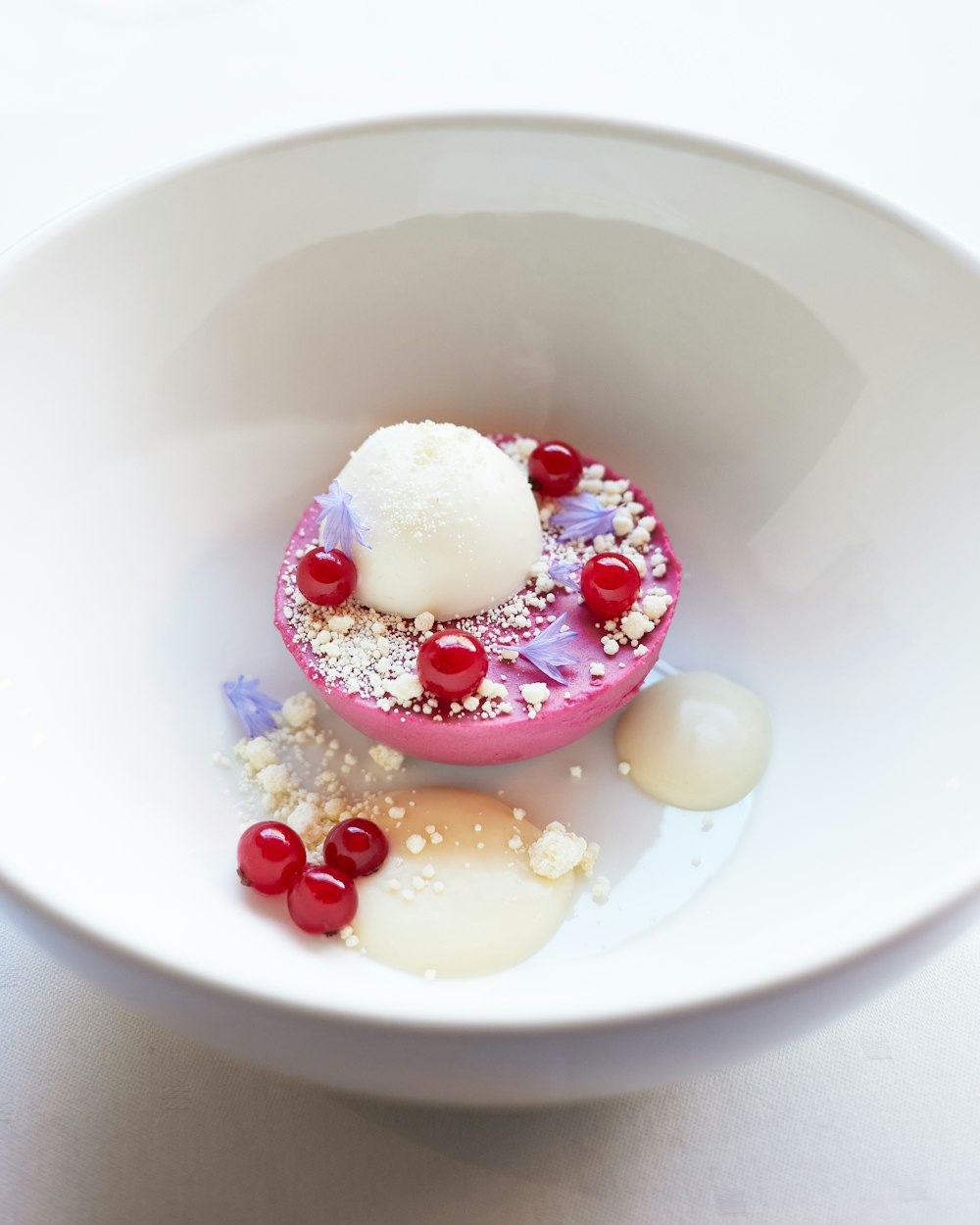 a white bowl filled with food on top of a table