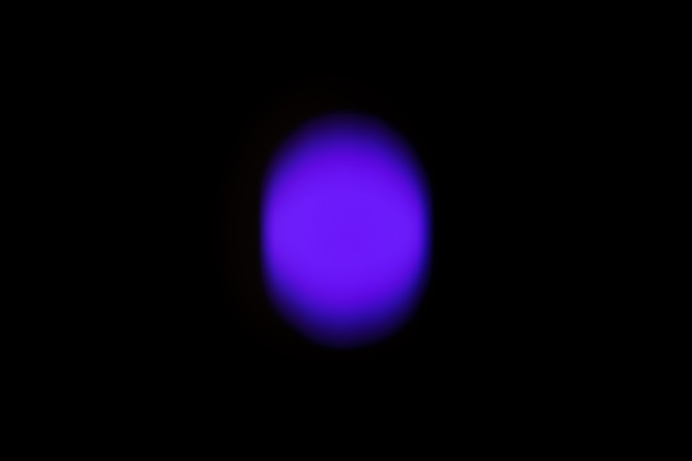 a blurry image of a blue ball in the dark