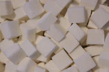 a pile of white sugar cubes sitting on top of a table