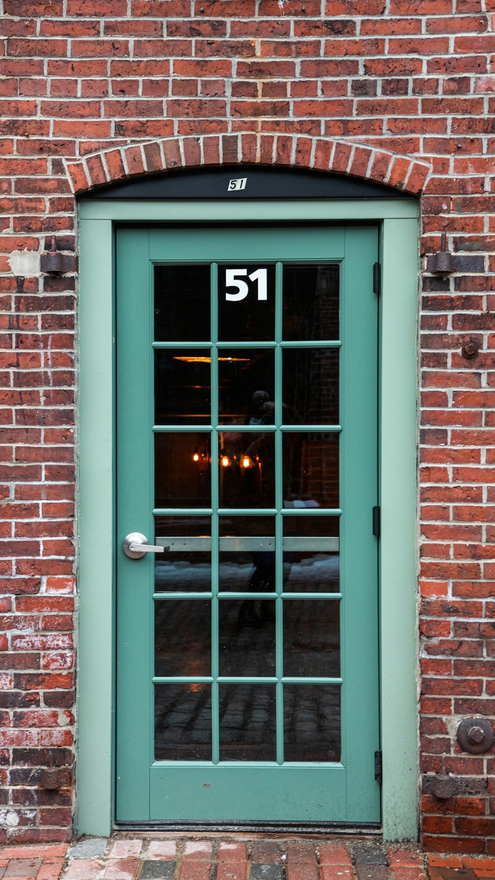 a green door with the number 51 on it