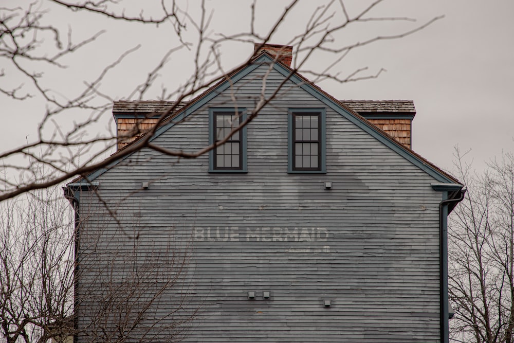 an old house with a sign on the side of it