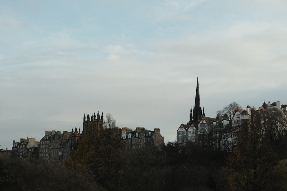 a city skyline with a church steeple in the background