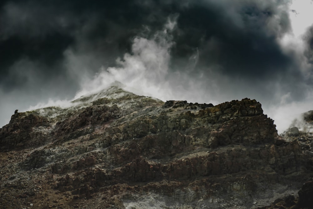 a large mountain with a very dark sky in the background