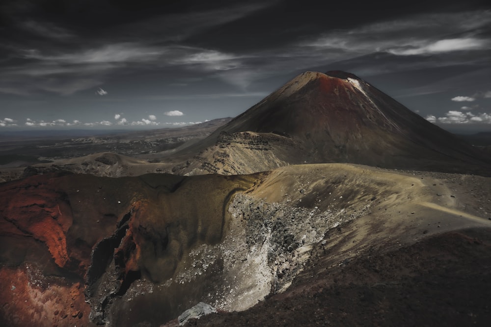 a very large mountain with a very dark sky in the background