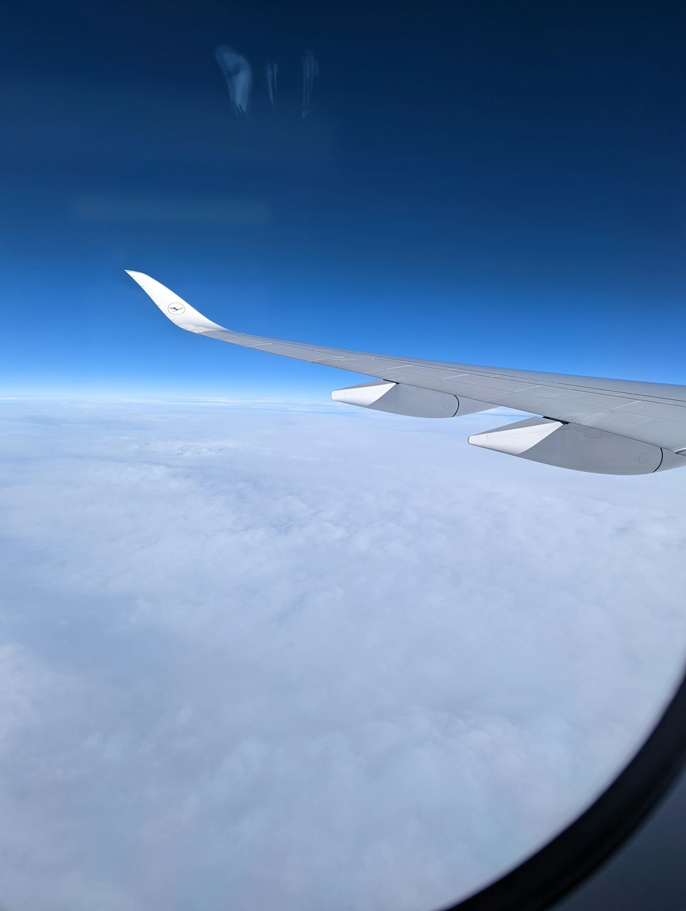 the wing of an airplane flying above the clouds