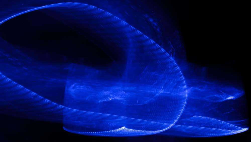 a close up of a blue ribbon on a black background