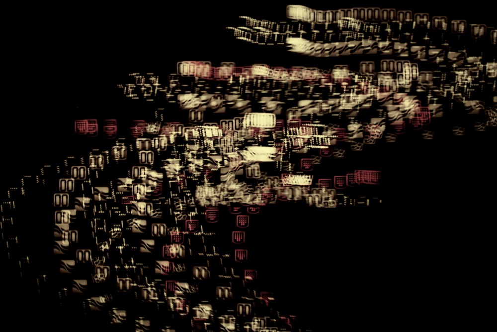 a blurry image of a black background with red and white squares