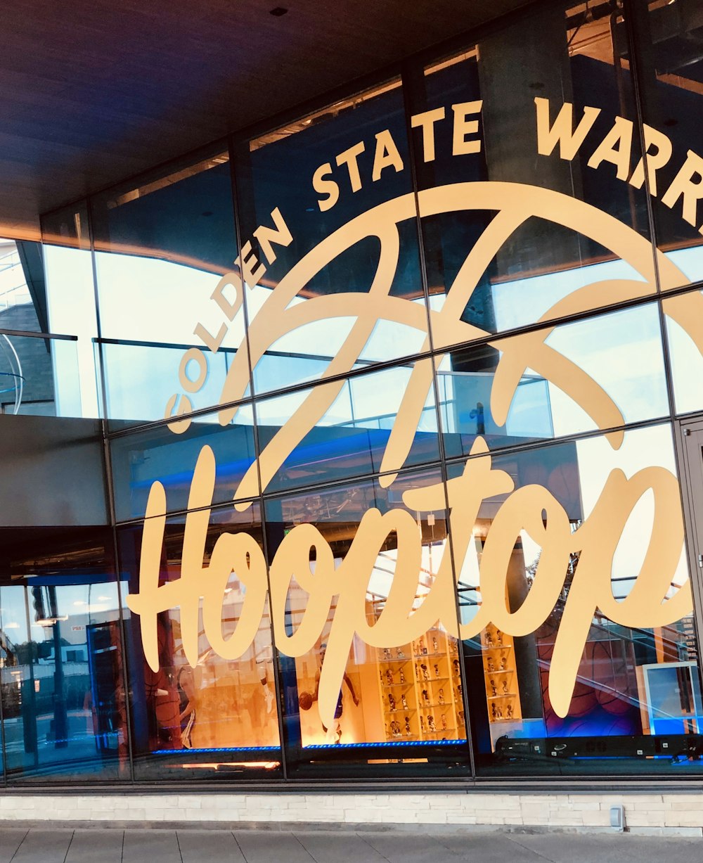 Un edificio di vetro con un cartello che dice Open State Warriors Hoop Hoop