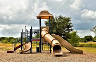 a playground with a slide and a play structure
