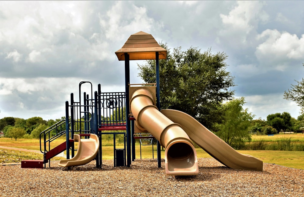 a playground with a slide and a play structure