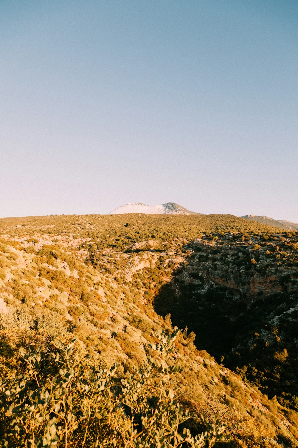 a view of a hill with a sky in the background