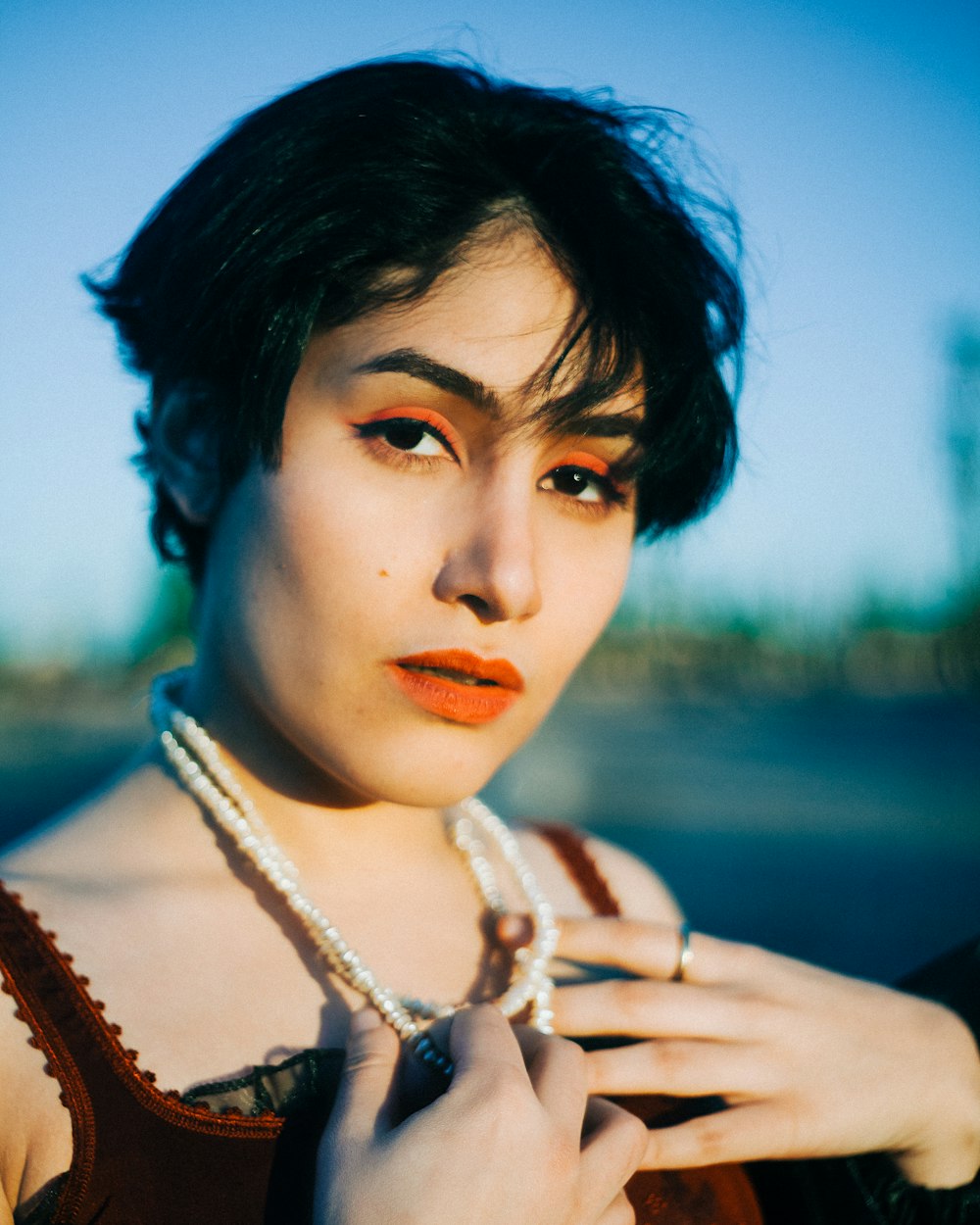 a woman with a necklace and pearls on her neck