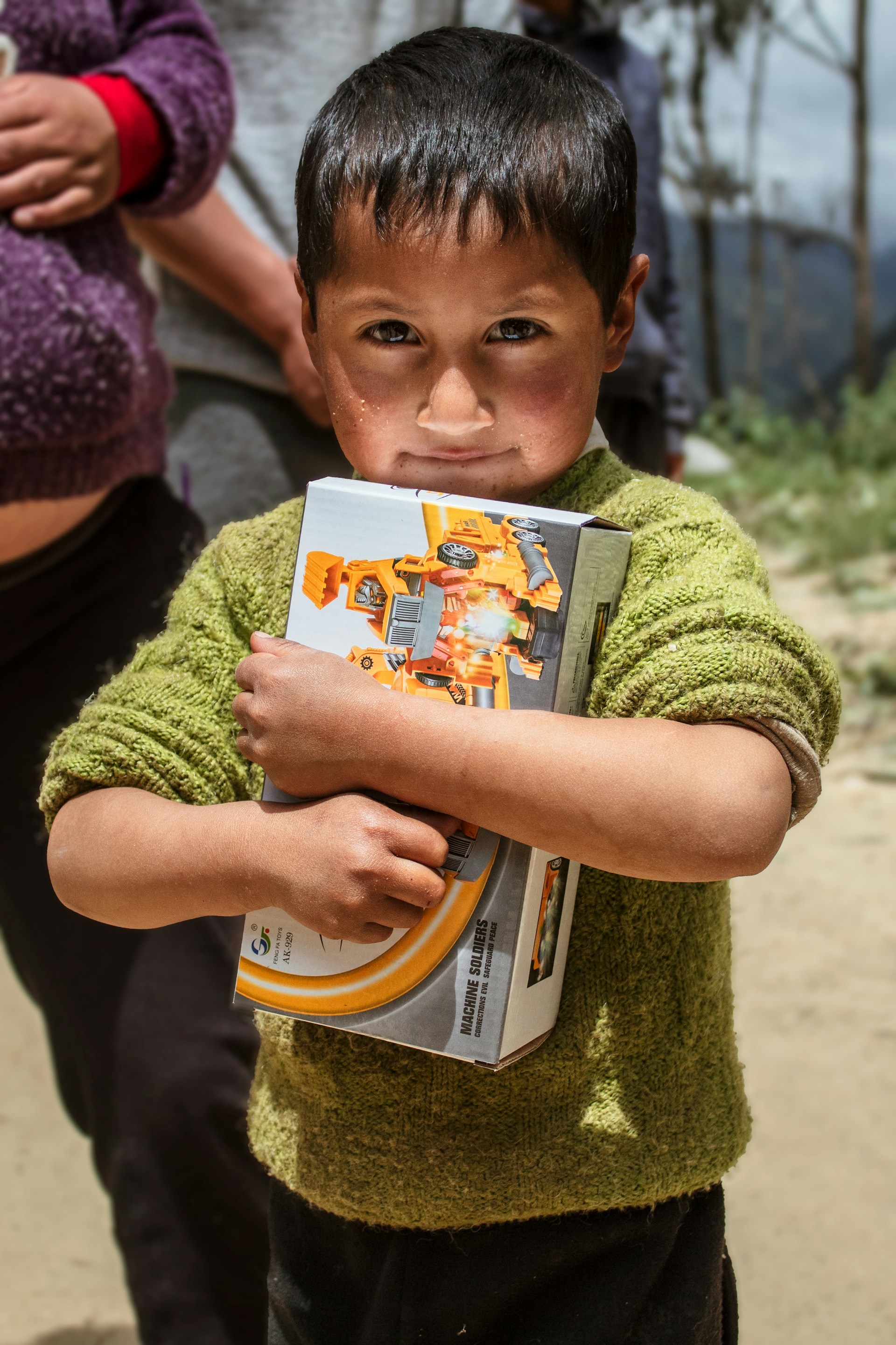 a young boy holding a book in his hands