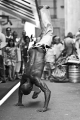 a man doing a handstand in front of a crowd