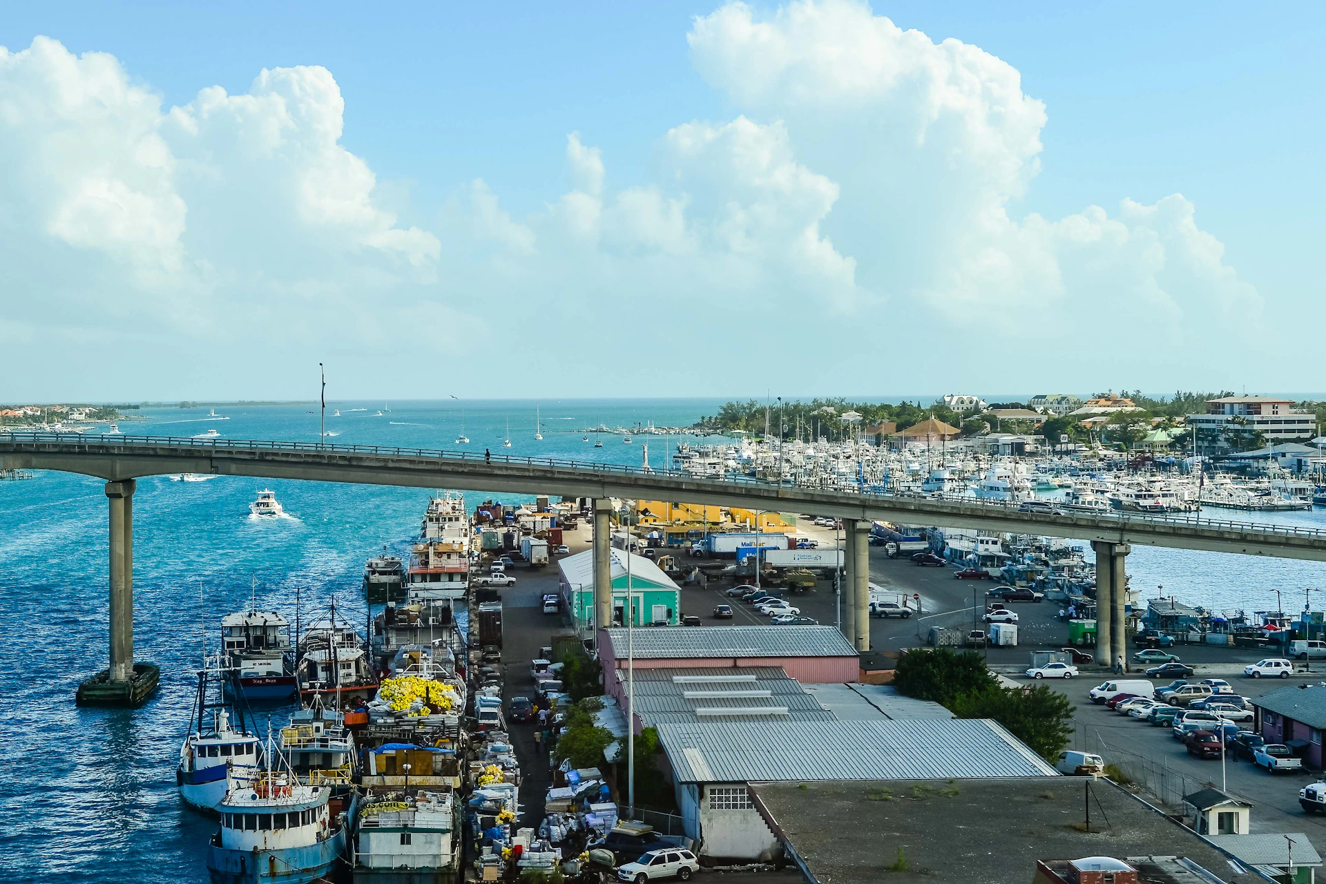 An overhead view of a fishing pier in Aransas Pass, with boats docked and the bustling activity of the coastal community.