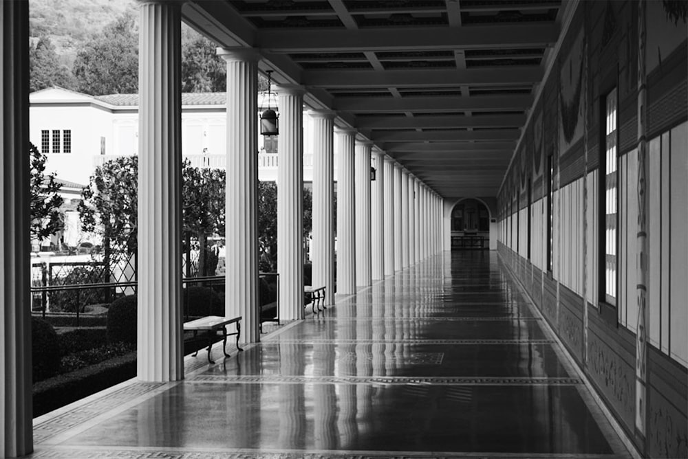 a black and white photo of a long hallway