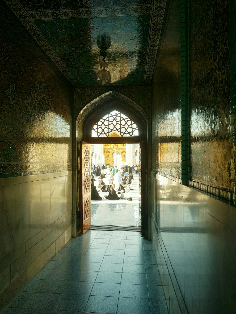 a hallway with a tiled floor and walls