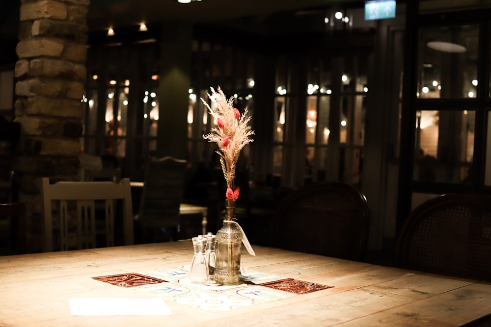 a wooden table topped with a vase filled with flowers