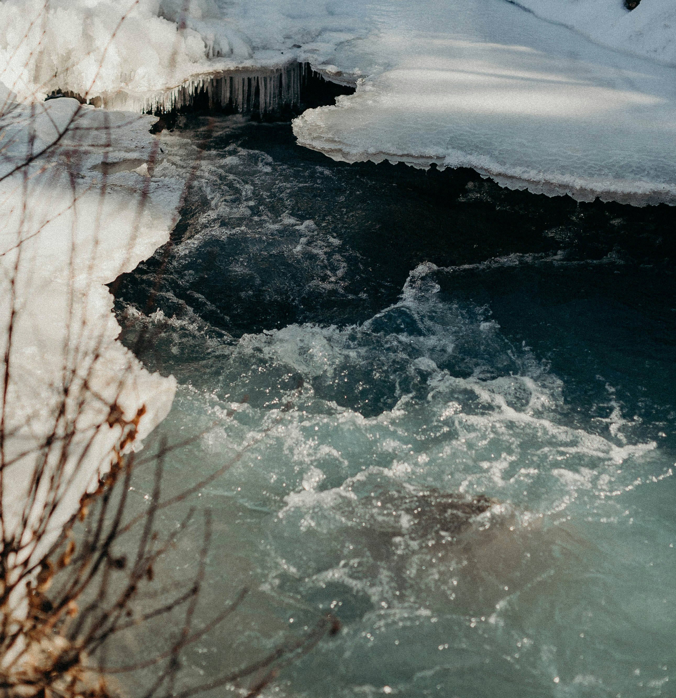 a river running through a snow covered forest