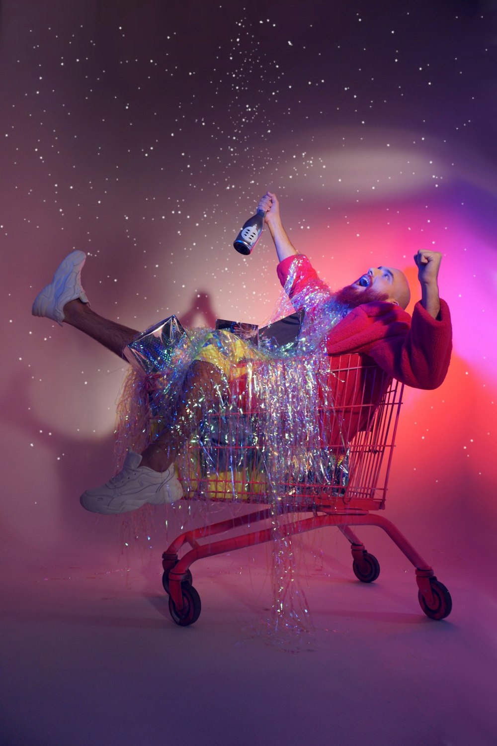 a man laying on top of a shopping cart