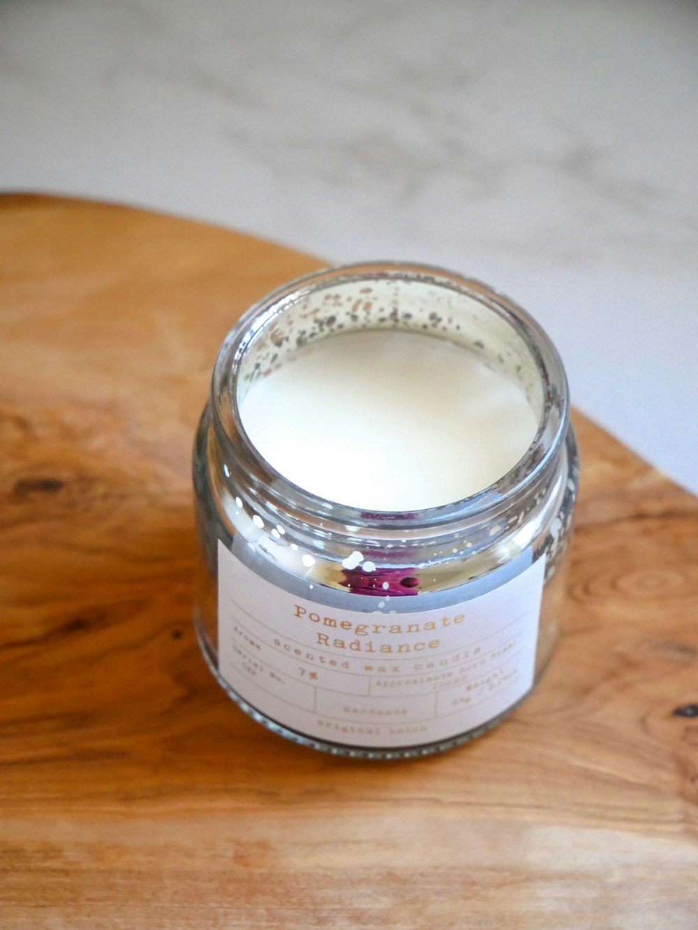 a jar of cream sitting on top of a wooden table