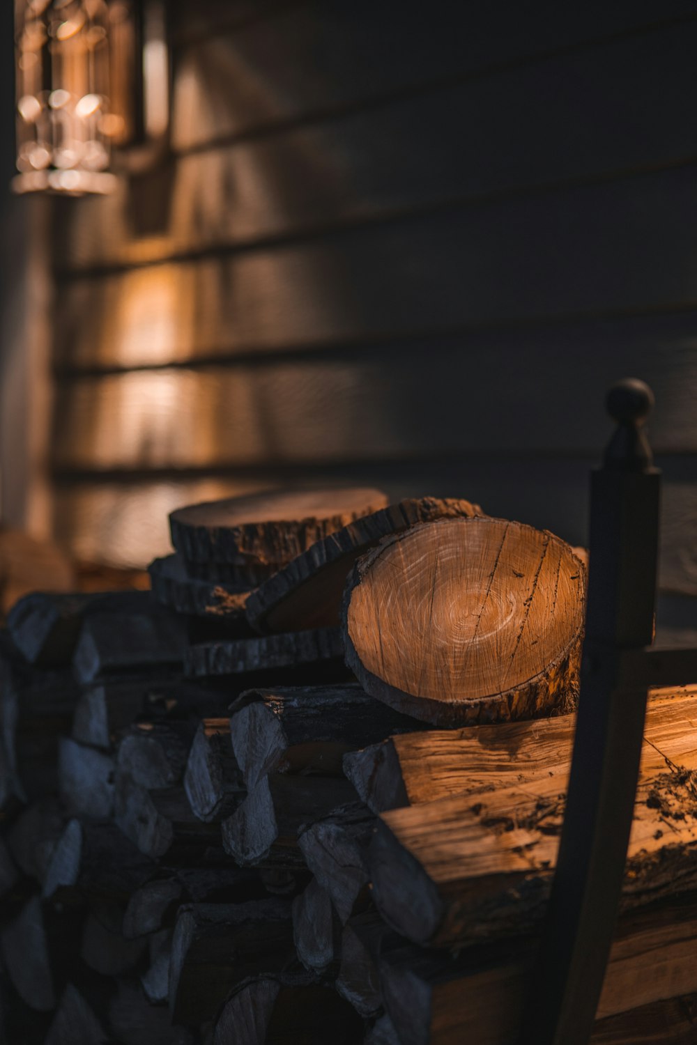 a pile of wood sitting on top of a wooden bench