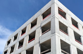 a tall concrete building under a blue sky