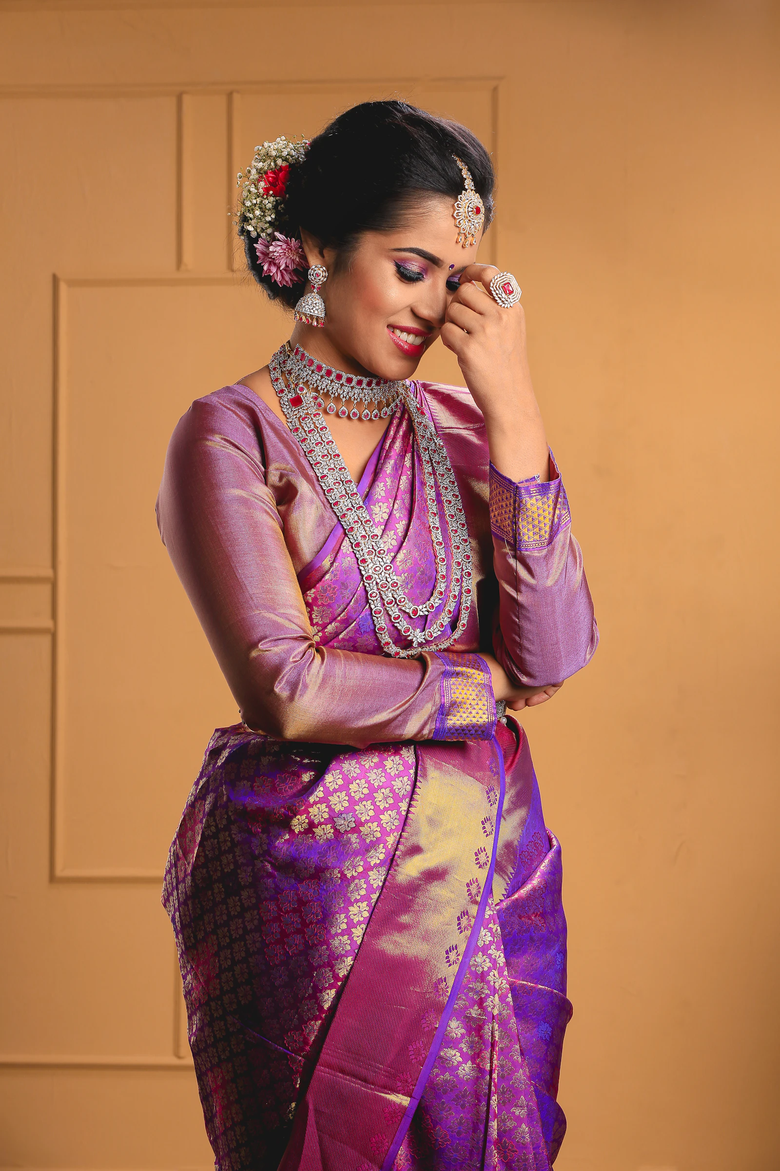 A purple and gold Banarasi silk saree with intricate zari brocade work