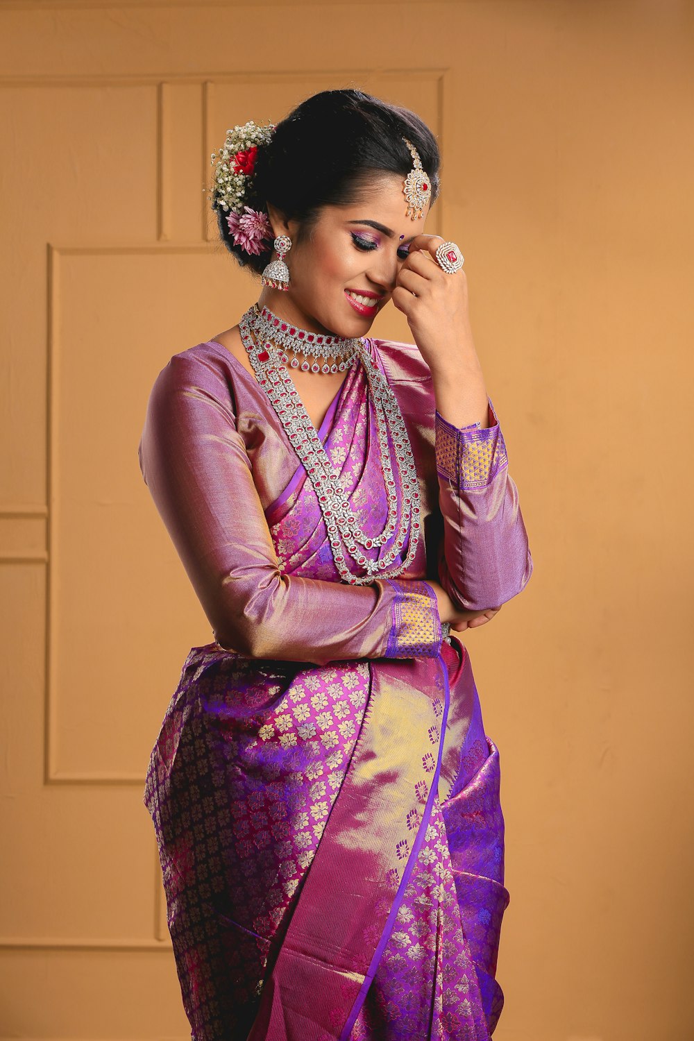 a woman in a purple and gold sari