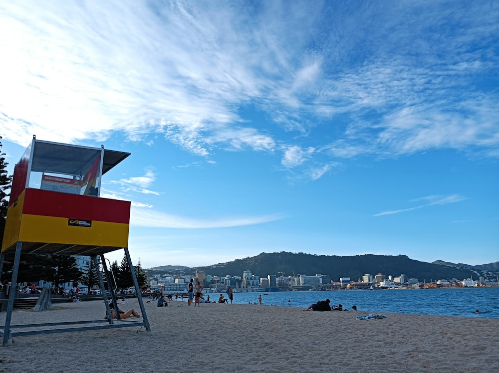 a lifeguard stand on a beach with a city in the background