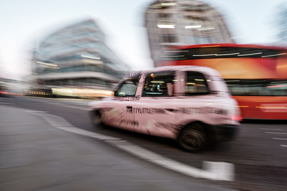 a blurry picture of a taxi cab driving down a street