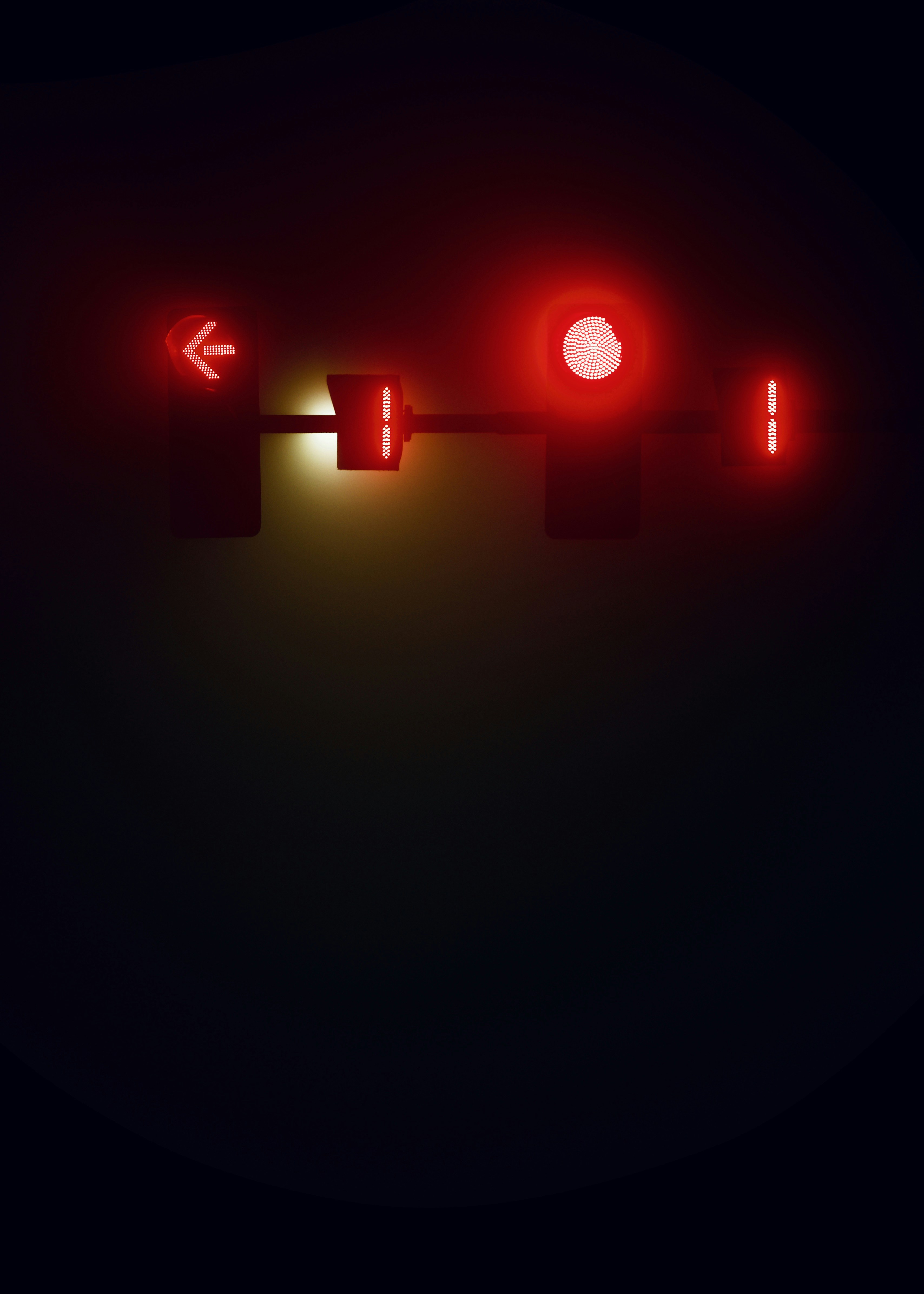 a red traffic light sitting on the side of a road