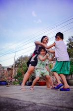 a group of young children playing a game of frisbee