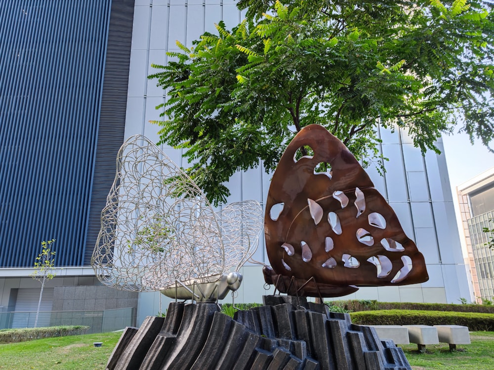 a sculpture of a butterfly and a bird on a tree stump