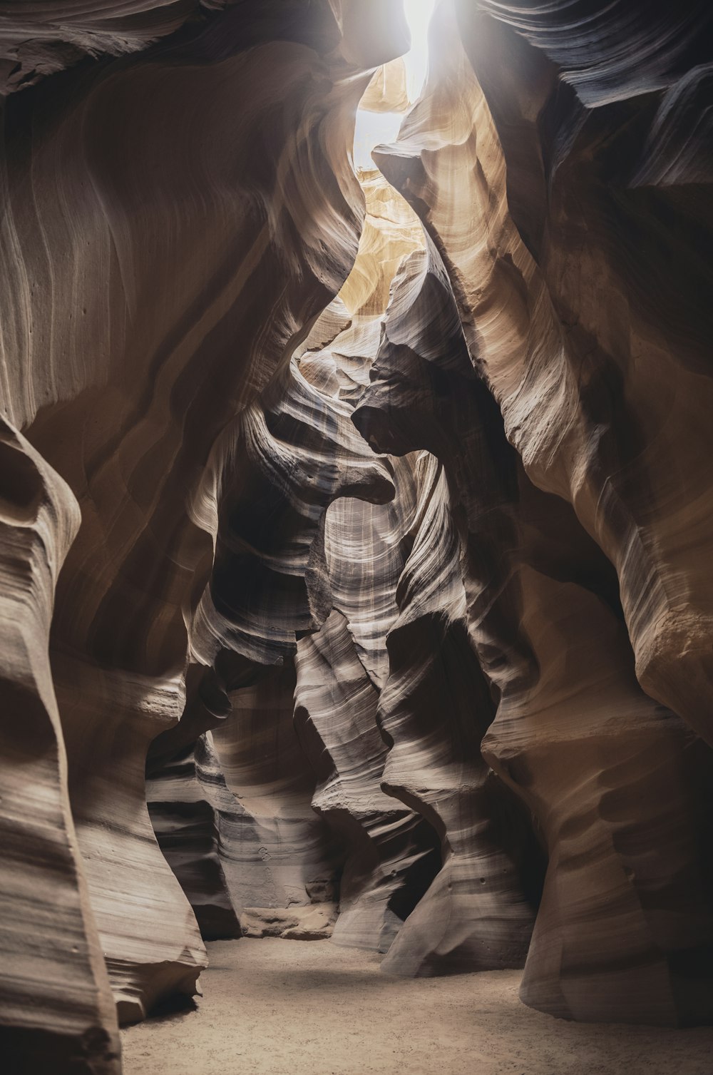 a light shines in the middle of a narrow canyon