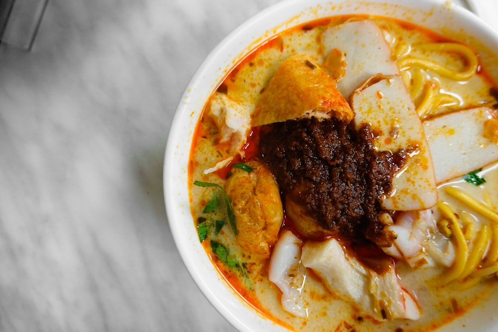 a bowl of noodles with meat and vegetables