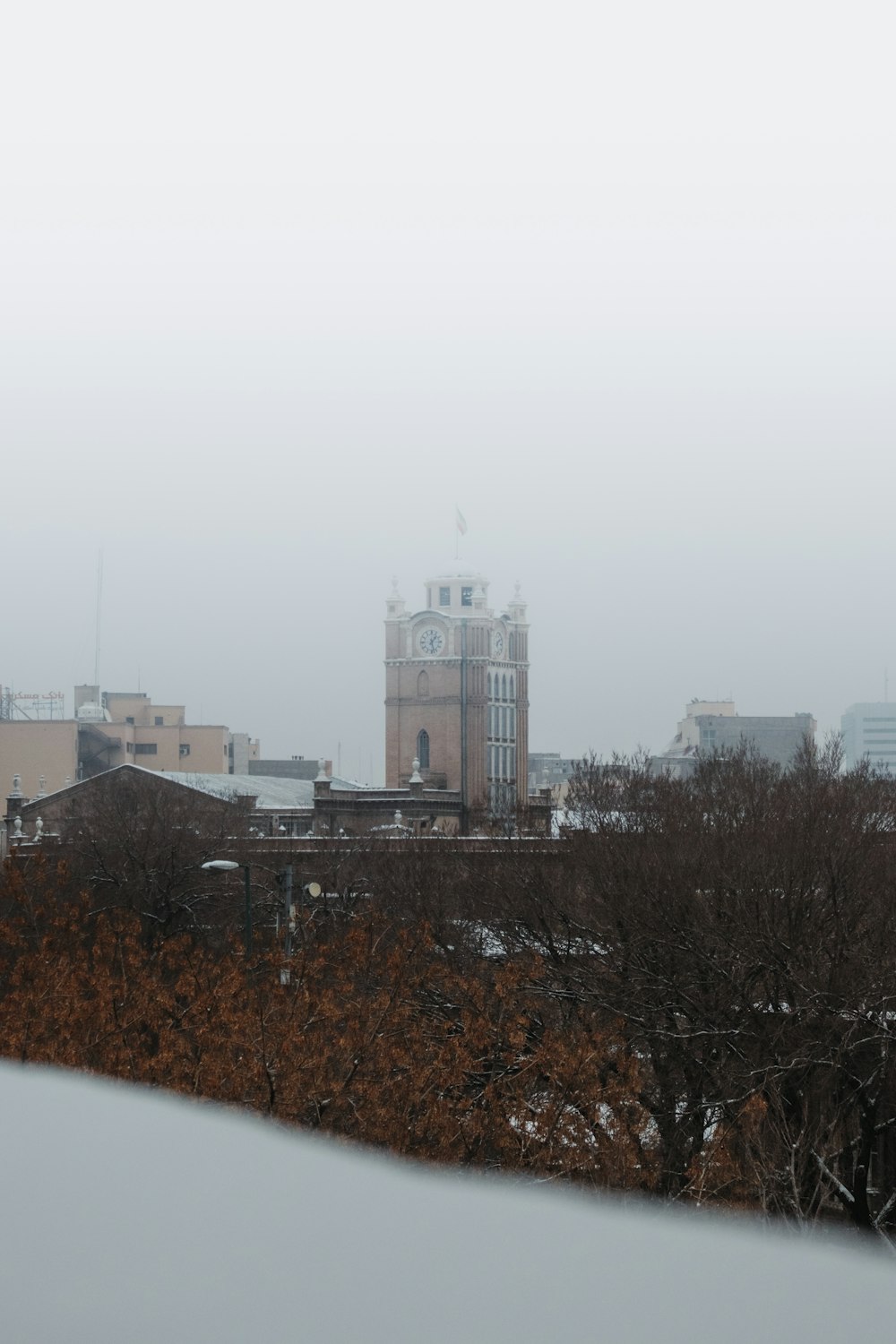 a view of a city with a clock tower in the distance