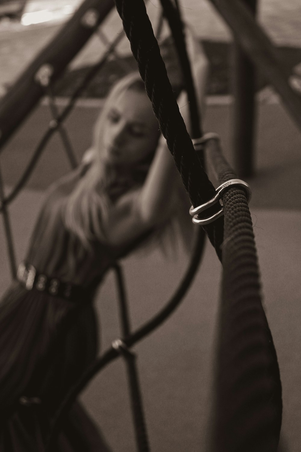 a woman sitting on a swing in a playground